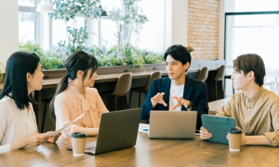 男女4人が会話をしている様子 イメージ写真